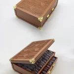 Brown leather date box with a wave-patterned lid, gold metal corner accents, and two layers of premium dates.