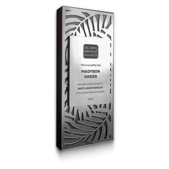 laser-cut-metal-award A tall rectangular metal award with tropical leaf cutouts and an engraved plaque reading ‘Global Makeup Awards.