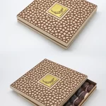 Natural-toned gift box adorned with a laser-cut geometric design, showcasing premium dates in a sliding drawer