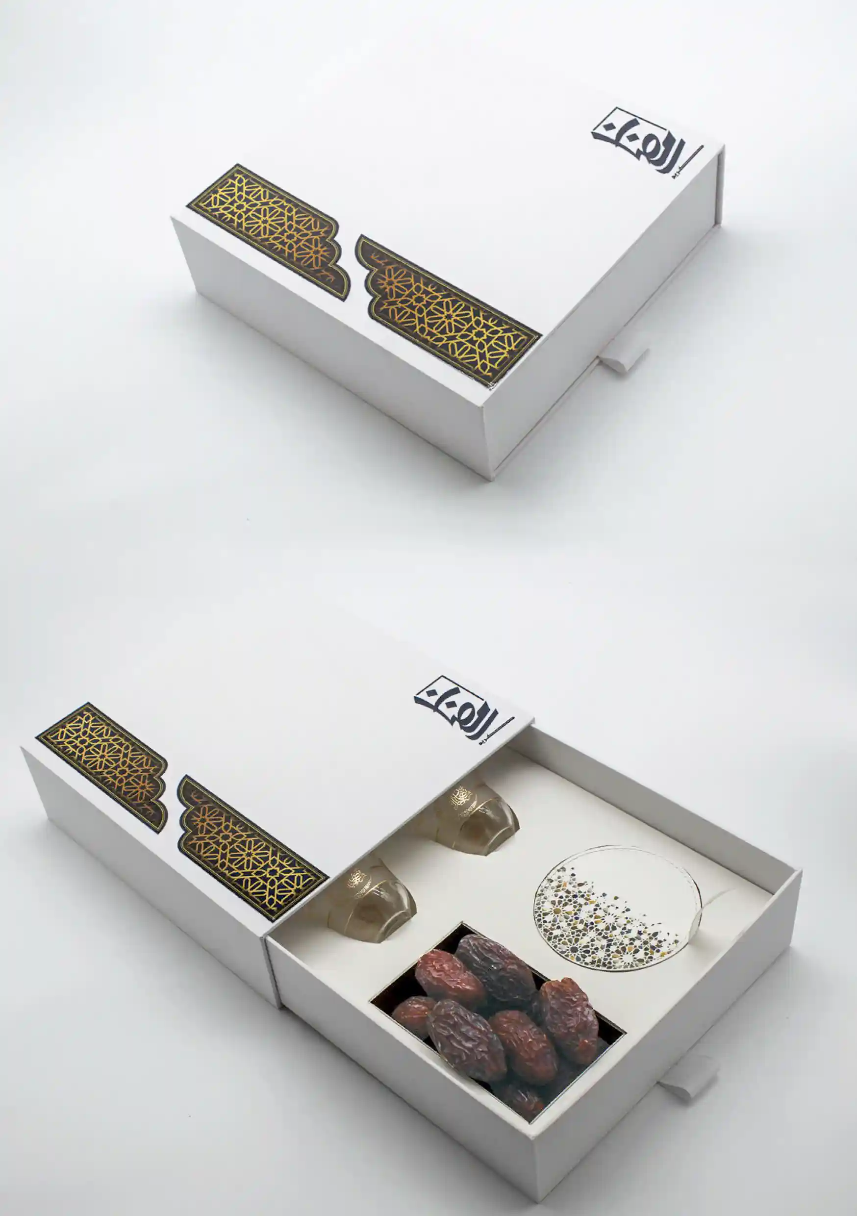 Sleek white drawer-style Ramadan box highlighted by golden Islamic motifs, opened to reveal elegant qahwa cups and fresh dates