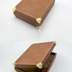 Brown leather date box featuring a geometric etched pattern and gold metal corners, opened to reveal premium dates