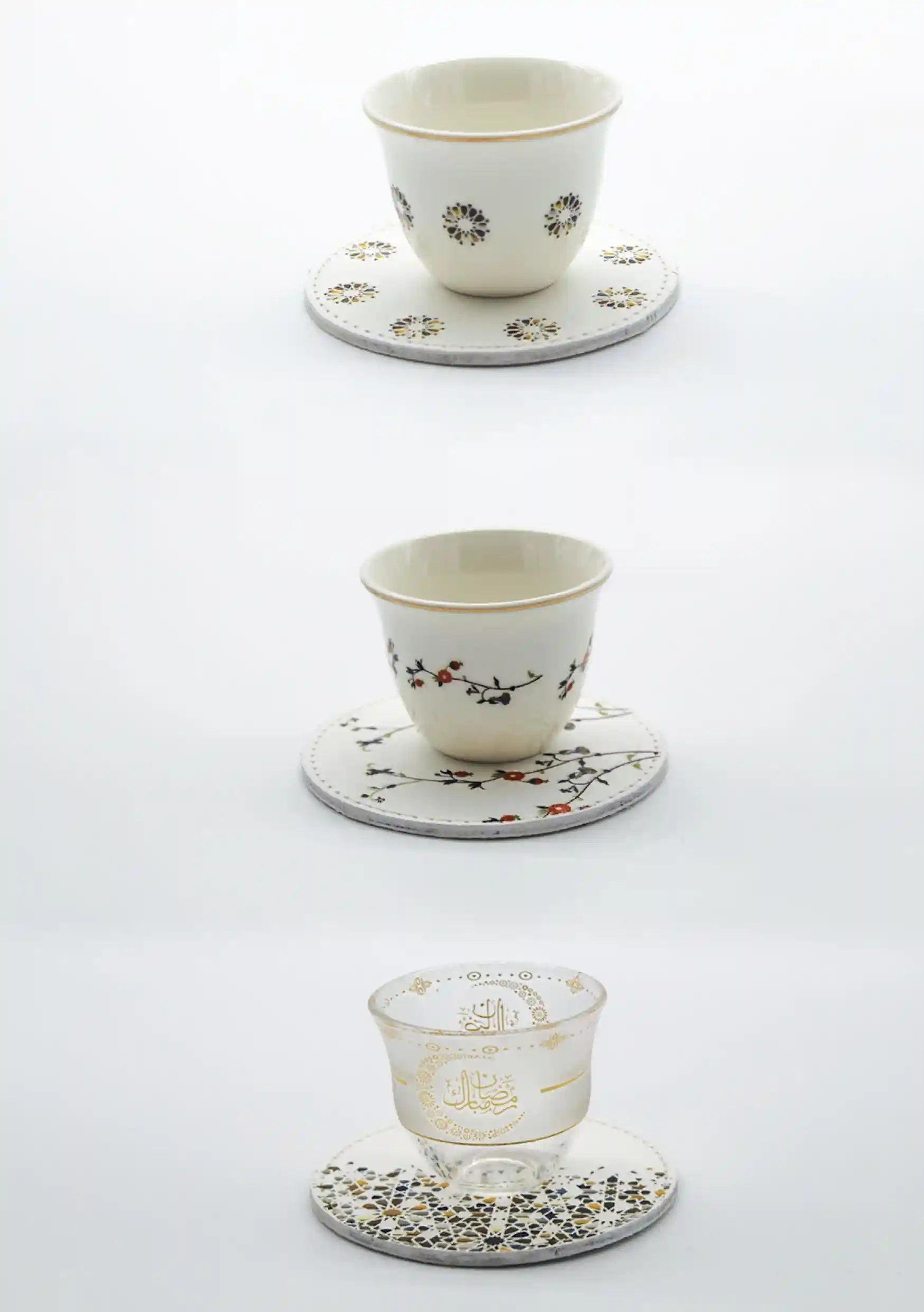 A trio of Arabic coffee cups and matching coasters, each decorated with intricate Islamic patterns and Ramadan greetings