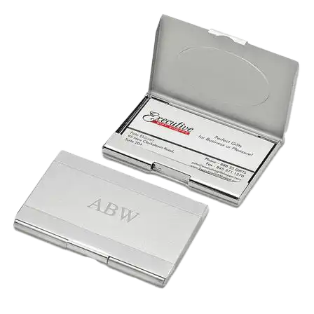 silver-metal-business-card-holder A sleek silver-colored business card holder engraved with the initials ‘ABW,’ displayed open with a sample business card. Gifts for CEOs in the UAE