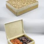 leather gift box featuring a laser-cut geometric lid, opened to reveal a selection of dried apricots and premium dates