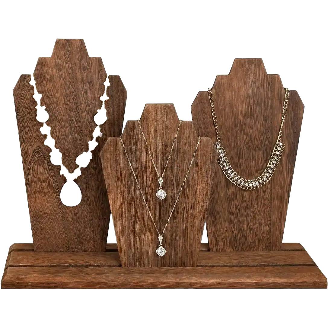 Three tall, wooden jewelry stands with varied shapes, displaying different styles of necklaces on a wooden base