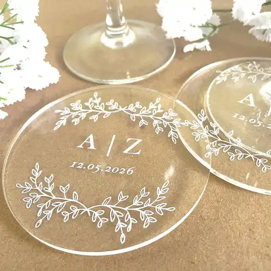 Round clear acrylic coasters engraved with initials A/Z and a date, decorated with a delicate floral border.