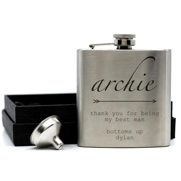 Stainless steel flask engraved with a custom name and message, displayed with its gift box and funnel 