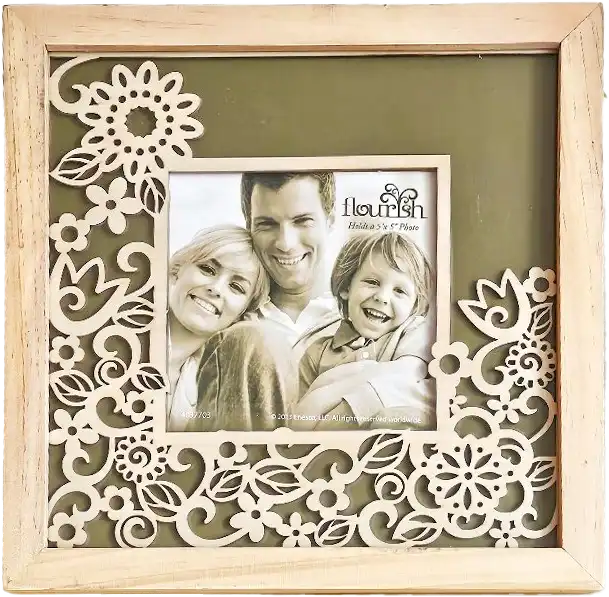 A light wood photo frame with intricate floral cutouts along the border, holding a family portrait