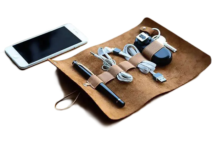 Leather roll-up cable organizer holding a pen, charging cords, and earbuds for a neat, travel-friendly setup Custom laser cutting