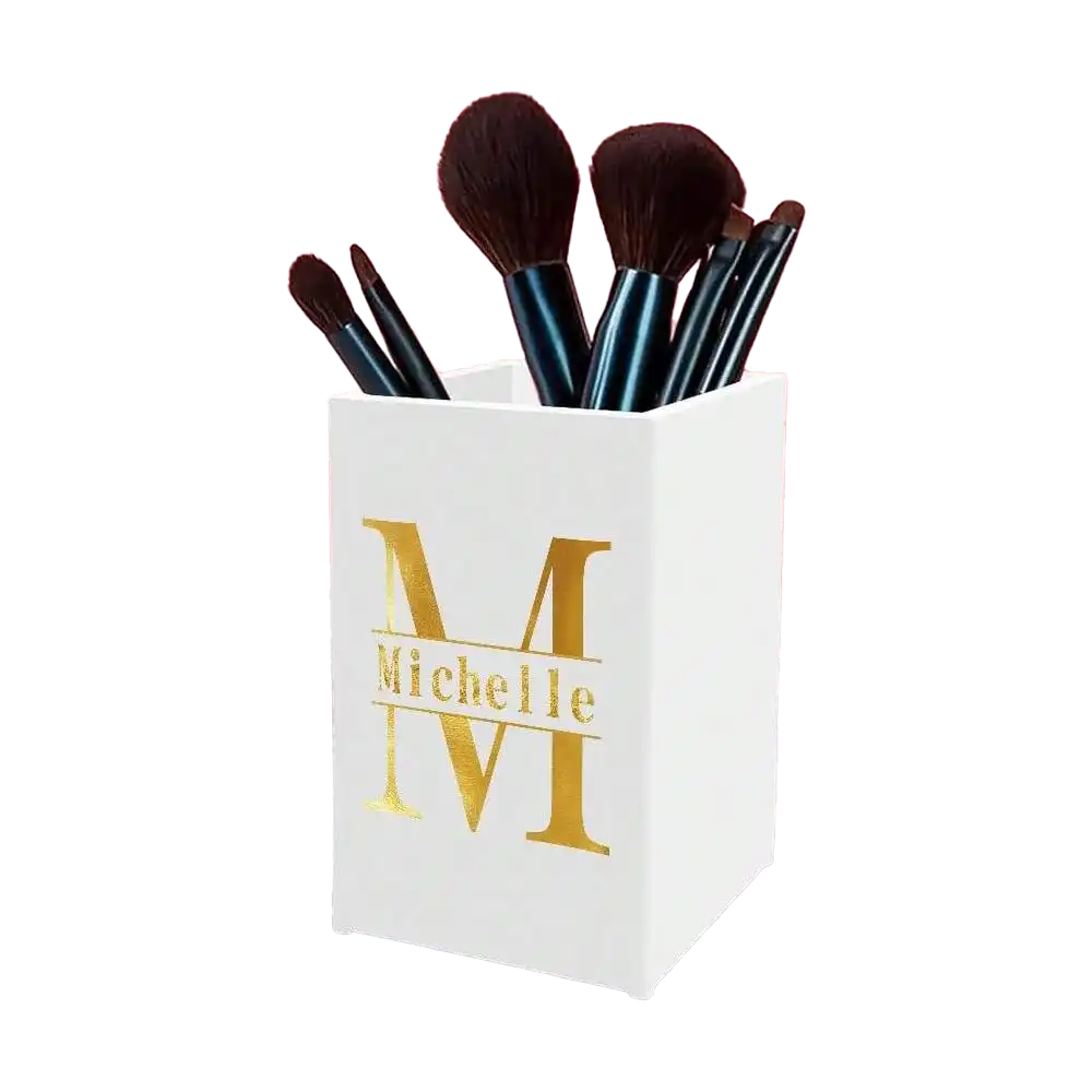 White acrylic brush holder with a gold monogram reading ‘Michelle,’ displayed alongside other possible custom letter designs. Gifts for Women