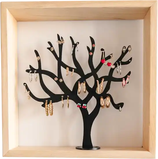A black tree-shaped jewelry holder mounted in a wooden box frame, showcasing earrings and necklaces
