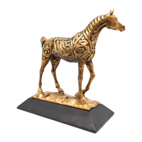 Arabian horse sculpture in antique gold finish with Arabic calligraphy, standing on a dark resin base.