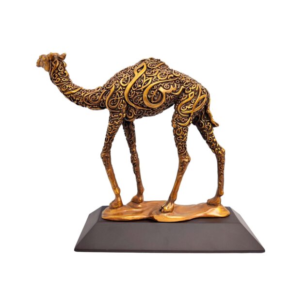 Antique gold camel sculpture with intricate Arabic calligraphy on body, standing on a flat base.