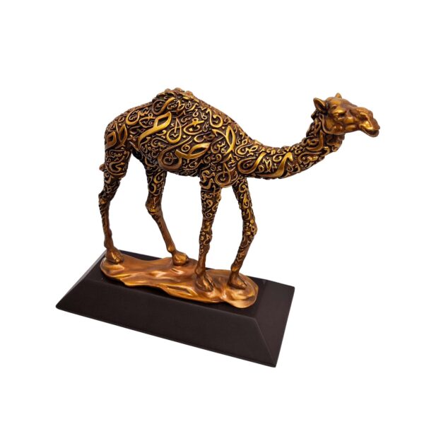 Antique gold camel sculpture with intricate Arabic calligraphy on body, standing on a flat base.