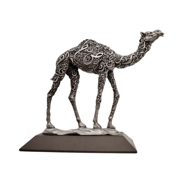Antique silver camel sculpture with intricate Arabic calligraphy on body, standing on a flat base.