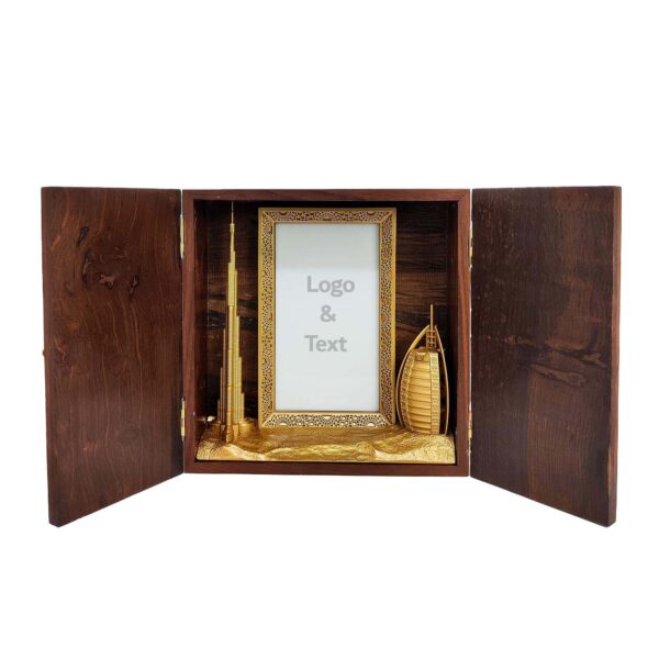 Wooden keepsake box featuring gold-finished 3D models of Burj Khalifa, Burj Al Arab, and Dubai Frame with customizable acrylic space.