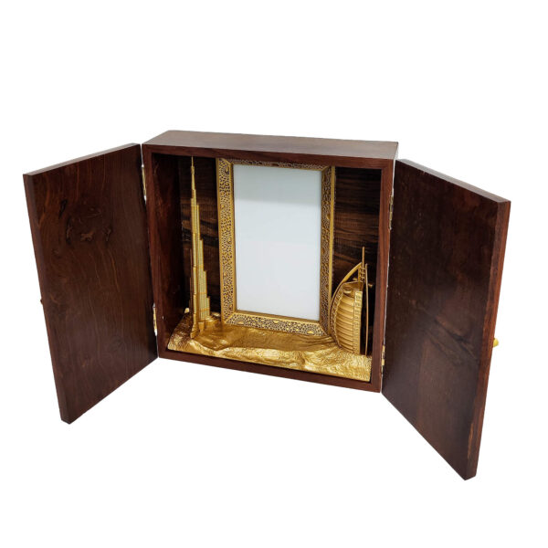 Wooden keepsake box featuring gold-finished 3D models of Burj Khalifa, Burj Al Arab, and Dubai Frame with customizable acrylic space.