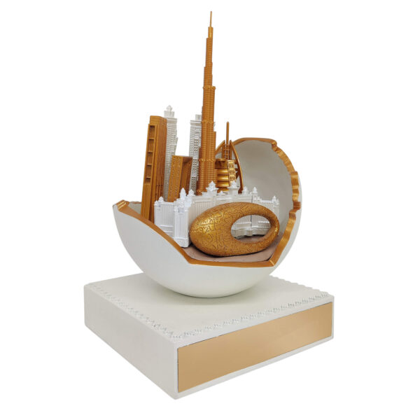 Dubai skyline sculpture featuring Burj Khalifa and Museum of the Future in gold finish, emerging from an abstract UAE Map in sphere with pearl finish