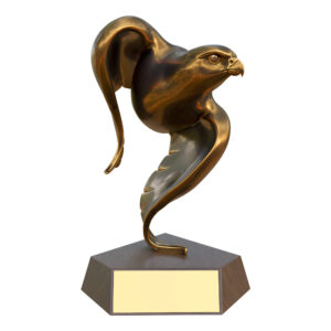 Antique gold falcon sculpture balanced on its wingtip, mounted on a dark walnut-finish base — symbolizing power and heritage.