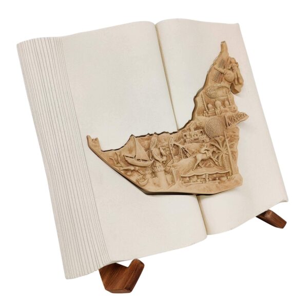 3D UAE map sculpture in an open book with bas-relief landmarks and a wooden display stand.