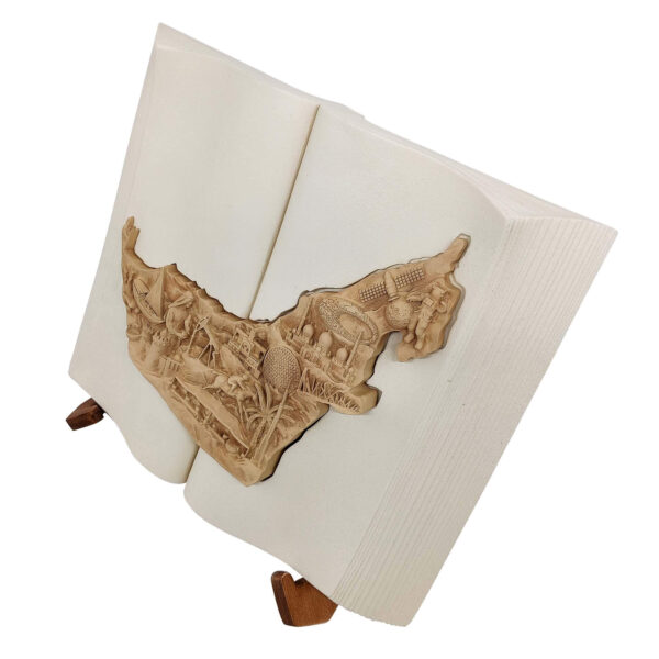 3D UAE map sculpture in an open book with bas-relief landmarks and a wooden display stand.