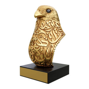Gold-finish Peregrine Falcon bust with Arabic calligraphy on a black base