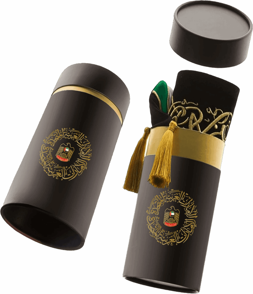 UAE National Day scarf in a luxury cylindrical gift box with gold embroidery, tassels, and the UAE emblem — part of the UAE National Day Gifts 2025 collection.