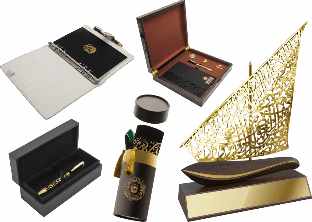Collection of UAE National Day Gifts 2025 including a vintage wooden VIP box, traditional gold dhow sculpture, luxury pen, white PU leather binder, and scarf cylinder box.