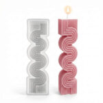 Clear silicone mold beside a lit pink wavy geometric pillar candle on a white background.