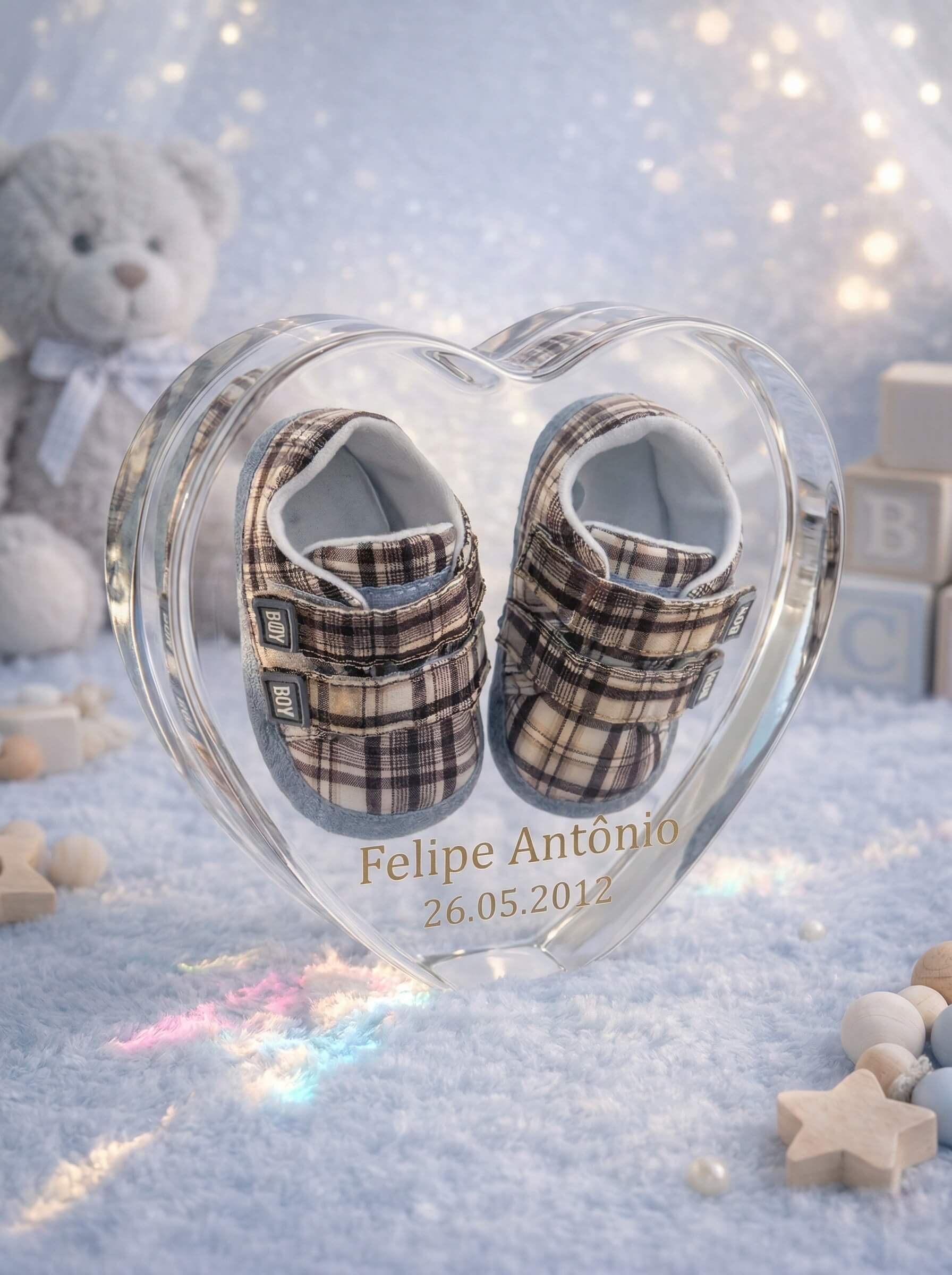 Clear heart-shaped epoxy resin block encapsulating a pair of plaid baby shoes with personalized gold text for the name and birth date.
