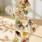 Custom clear epoxy resin figure shaped like Mario encapsulating various miniature toy characters inside.