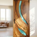 Sliding wooden barn door featuring curved live-edge wood sections joined by semi-transparent teal colored epoxy resin.